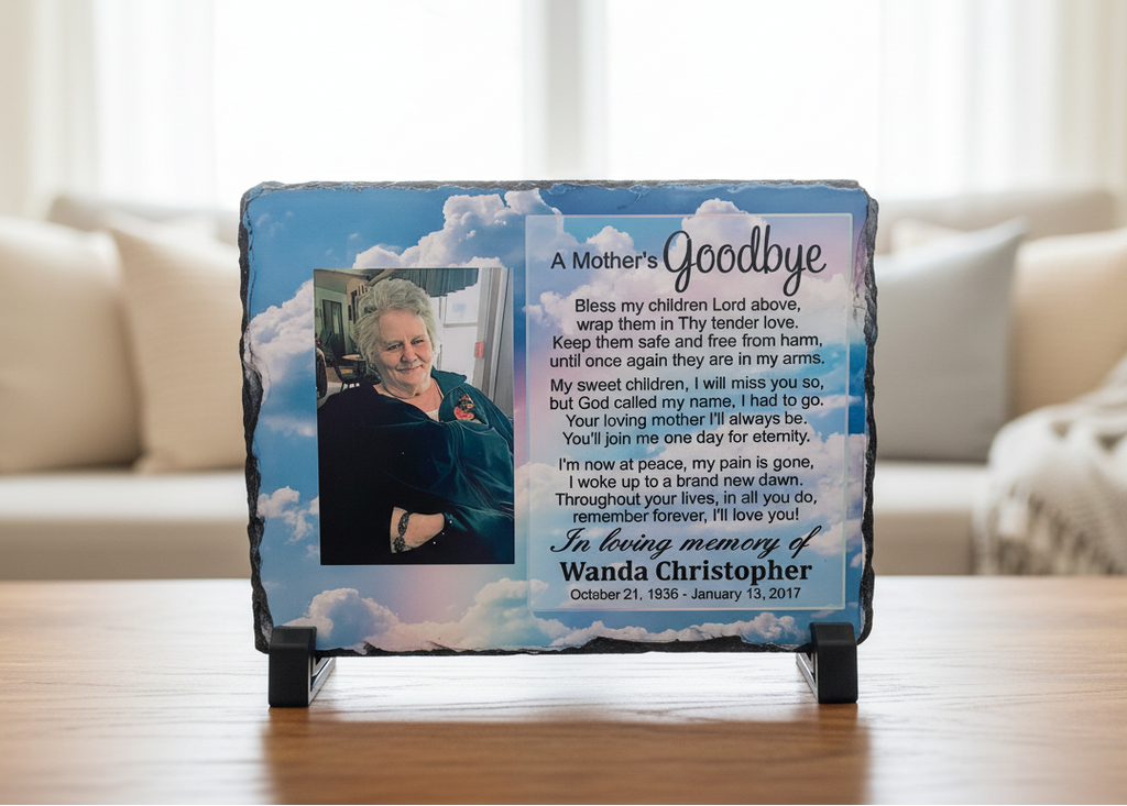 Front view of a custom rock slate memorial personalized with a photo and remembrance quote on black stands.