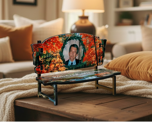 Side view of a personalized wooden miniature memorial bench photo display standing on a flat surface.