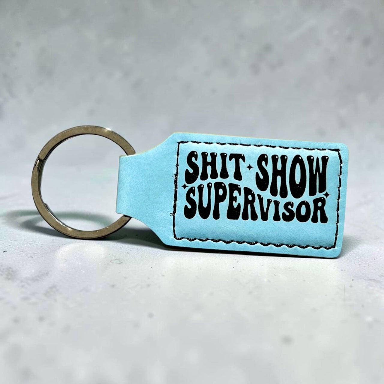 shit-show-supervisor-sky-blue-keychain